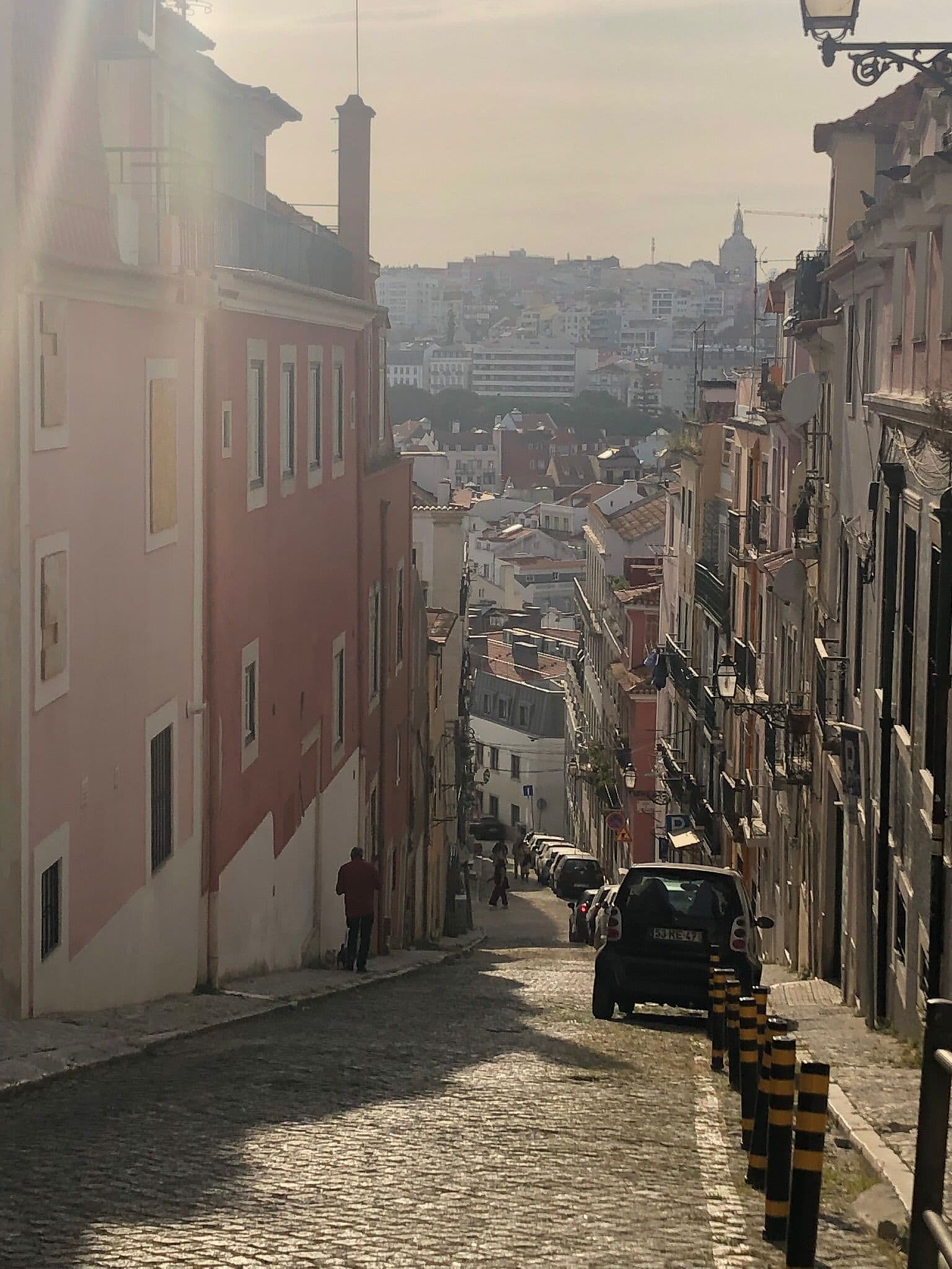 Sunlight falling into a steep Lisbon alley