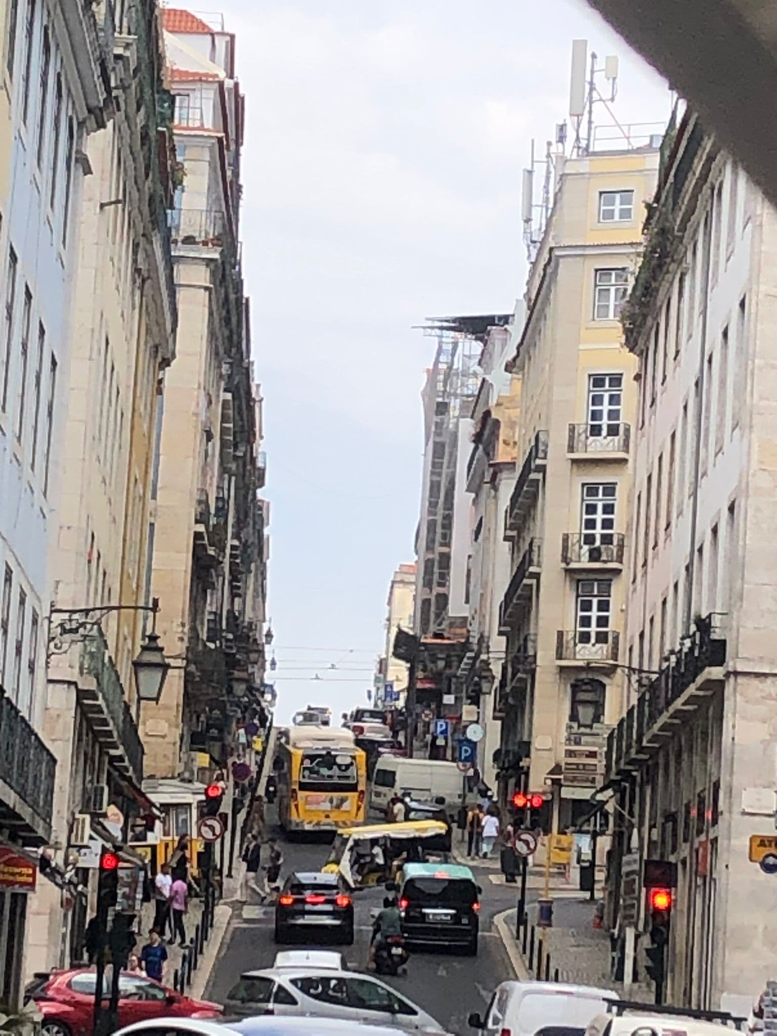 Busy Lisbon street with a yellow tram